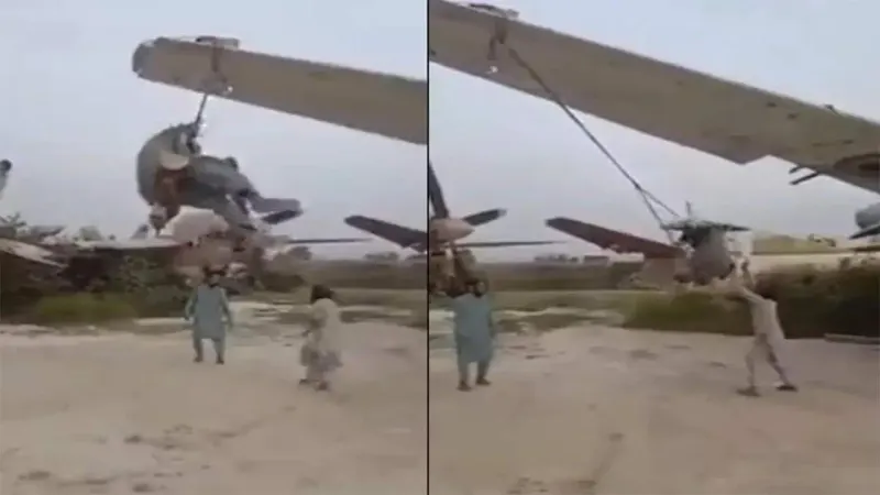Taliban soldiers using an aircraft as a swings.
