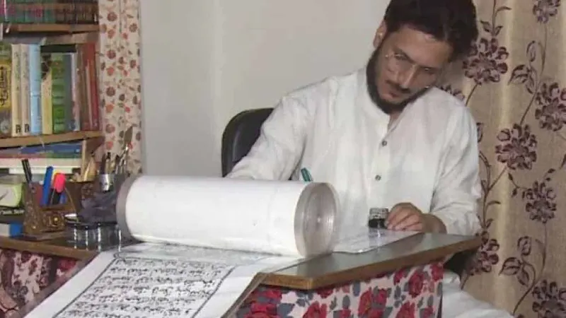Kashmiri man sets new record by writing Quran by hand on a single piece of paper