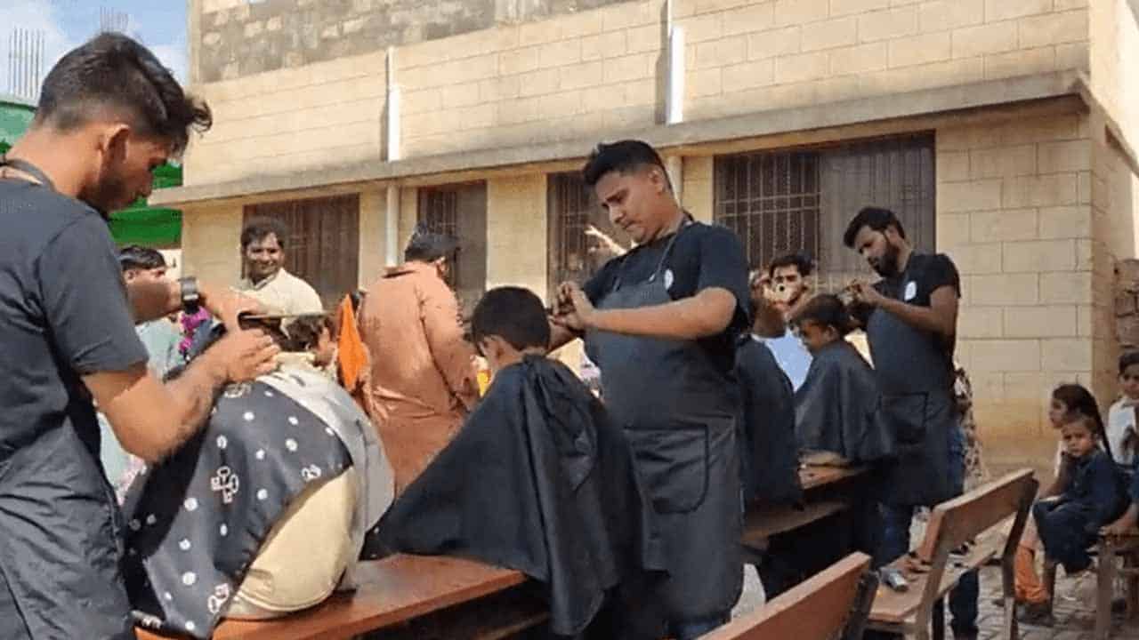 A group of friends brought joy to 250 kids at a Karachi flood relief camp by getting them haircuts